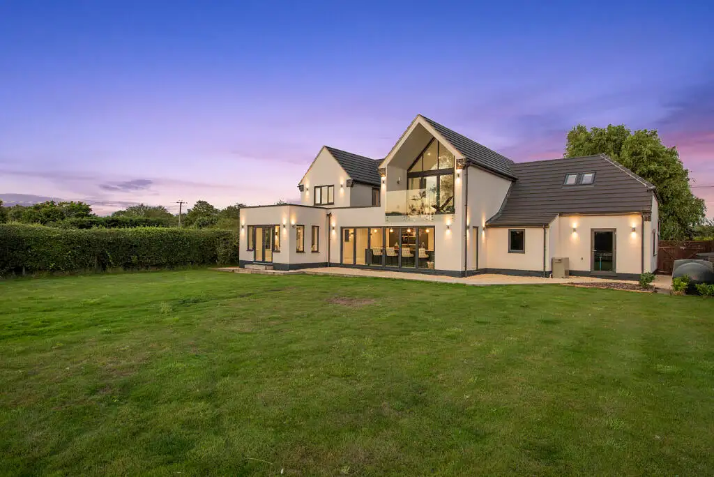 Rear elevation of the finished Graveley new build at dusk